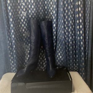 Navy leather wide calf knee boots that are made with comfort in mind
